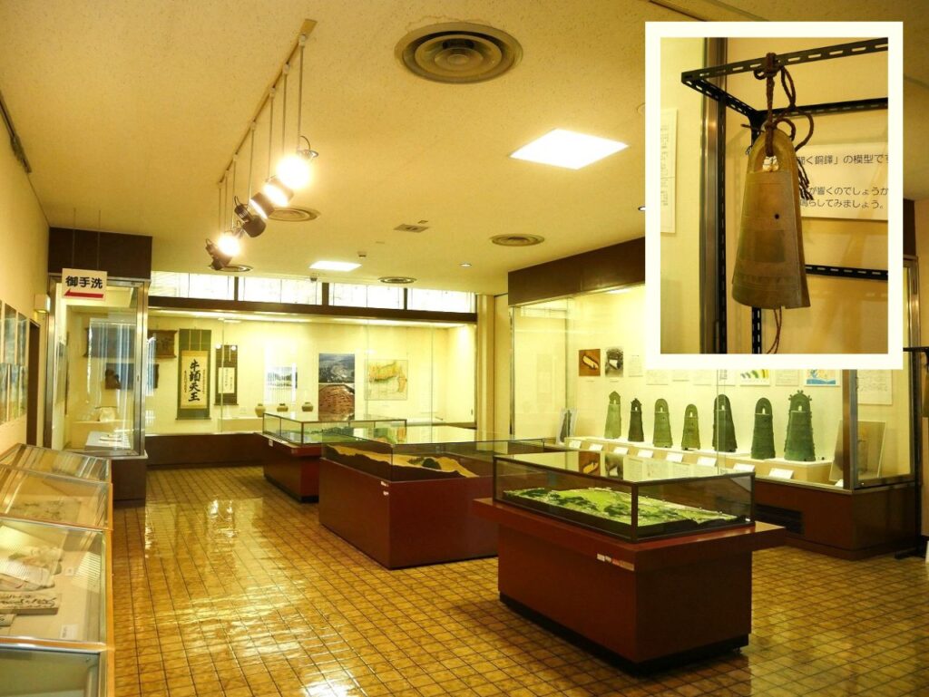 2階展示室内(右上:銅鐸展示ケース手前の「聞く銅鐸」の模型)