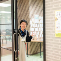 ユースセンターふらっとでにこやかに利用者を出迎える、スタッフの久住さん
